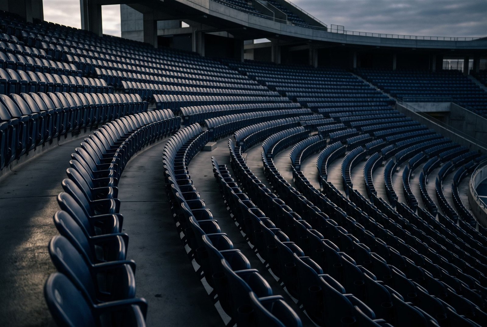 Sweeping curve of empty navy stadium seats